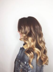 Brunette to honey blonde balayage with bouncy curls by Leslie Shores, Nashville colorist.