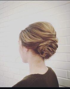 Elegant, textured low bun updo on dimensional golden blonde hair by Rebecca Erickson, Nashville, TN hairstylist