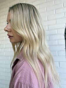 Dark root melt into bright platinum blonde styled in long soft waves by Lauren LeCompte, Nashville, TN hairstylist