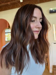 Rich mahogany brunette with warm caramel dimension styled in soft waves by Lauren LeCompte, Nashville, TN hairstylist
