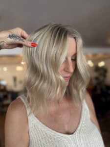 Dark root melt into dimensional blonde balayage styled in a wavy lob by Lauren LeCompte, Nashville, TN hairstylist