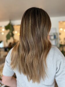Dark root melt into warm caramel balayage styled in long layered waves by Lauren LeCompte, Nashville, TN hairstylist
