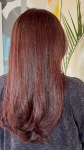 Sleek straight rich auburn red hair color with flipped ends by Taylor Smith