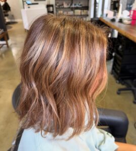 Copper brunette with golden blonde highlights styled in a wavy lob by Tami Whiteside, Nashville, TN hairstylist