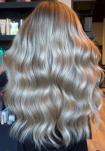 Dimensional beige blonde balayage styled in long, full waves by Annie Miller, Franklin, TN hairstylist