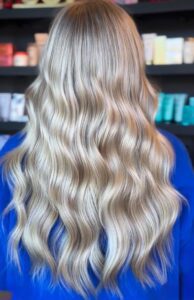 Dark root melt into dimensional blonde balayage styled in long waves by Annie Miller, Franklin, TN hairstylist