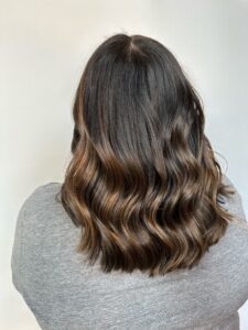 Dark root melting into warm caramel balayage with soft waves by Gabby Allen, Lebanon, TN hairstylist